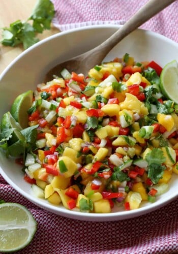 Fresh salsa made with mango in a bowl with a spoon