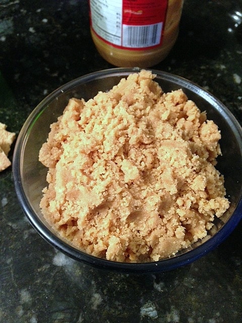 Overhead view of a batch of crumbly peanut butter cup spread in a bowl