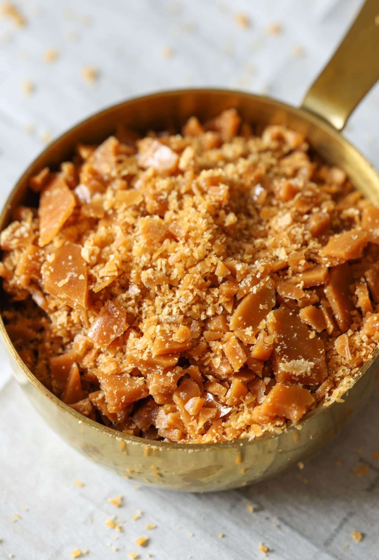 homemade toffee pieces in a measuring cup