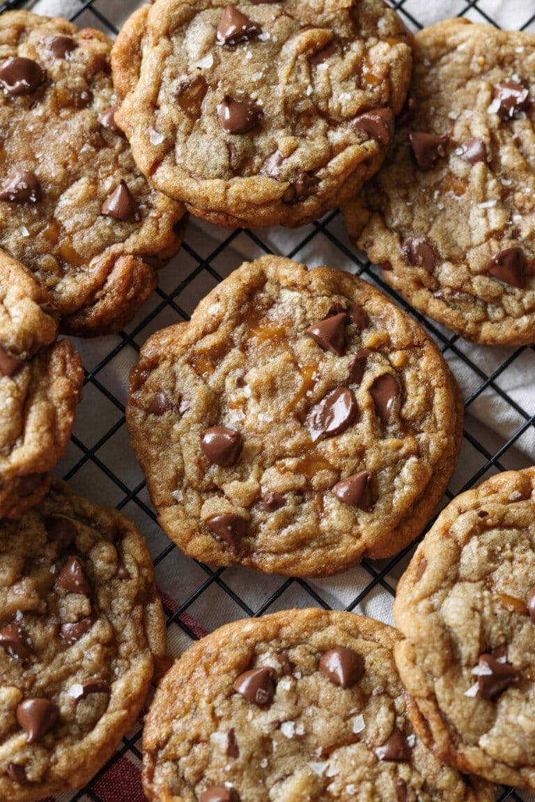 Butter Crunch Chocolate Chip Cookies served on wire rack with flaky sea salt