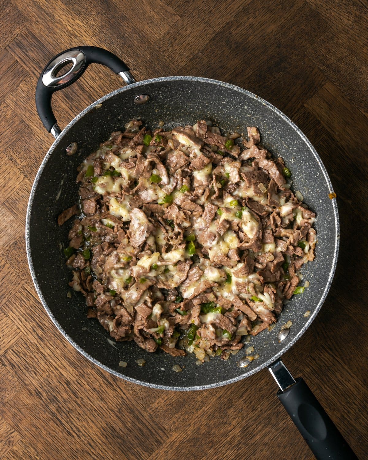 Philly cheesesteak mixture in a skillet.