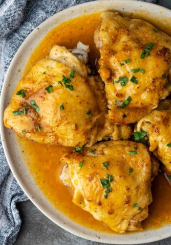 Top view of instant pot chicken thighs on a plate smothered with gravy.