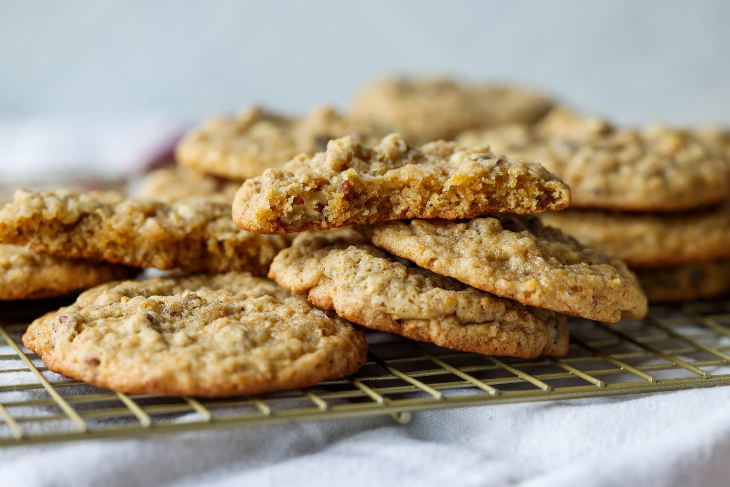 stacked pecan cookies on a wire cooling rack