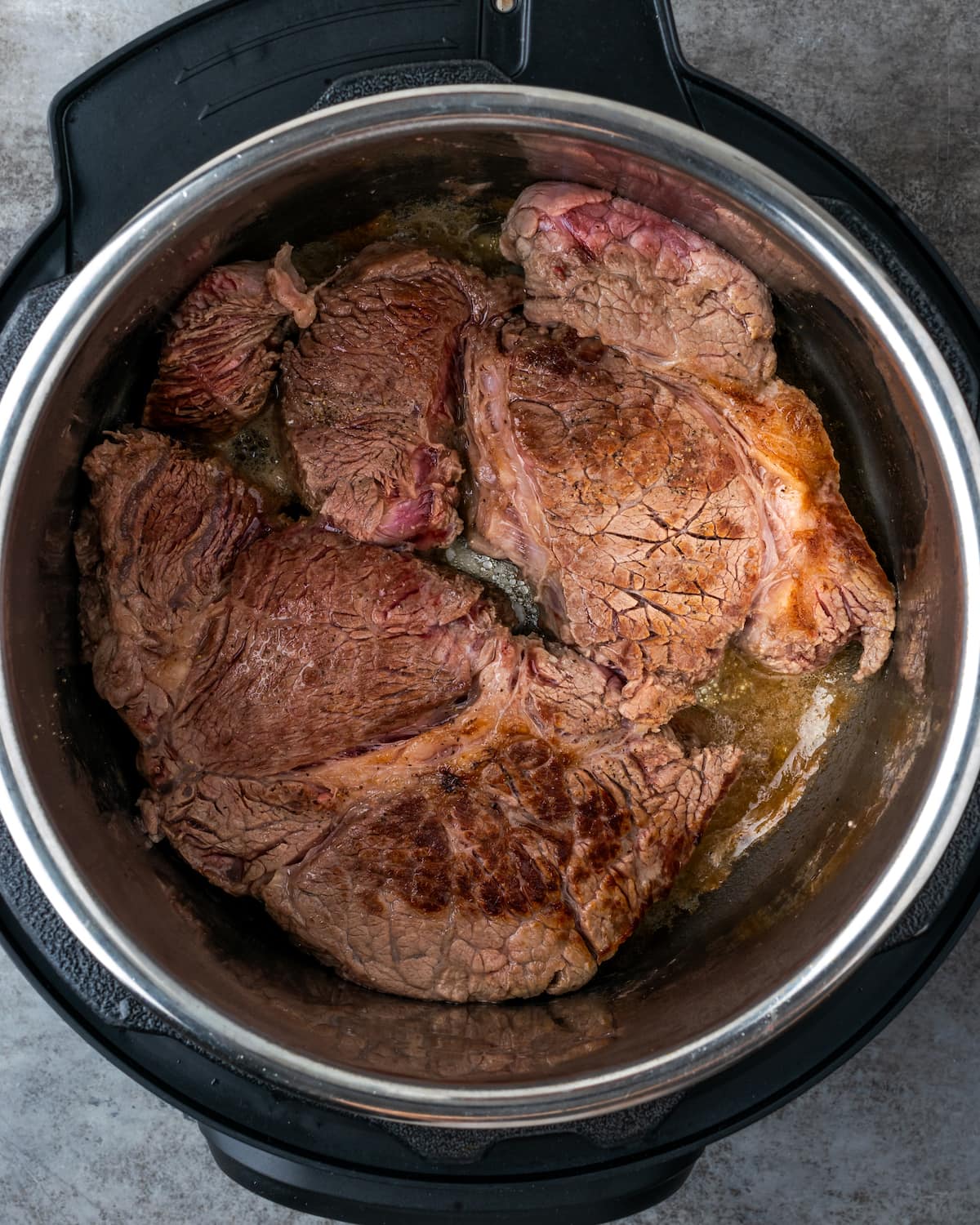 Seared chuck roast inside the Instant Pot.