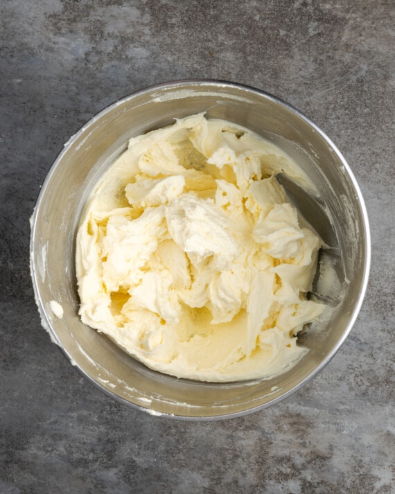 Mascarpone filling ingredients combined in a metal mixing bowl.