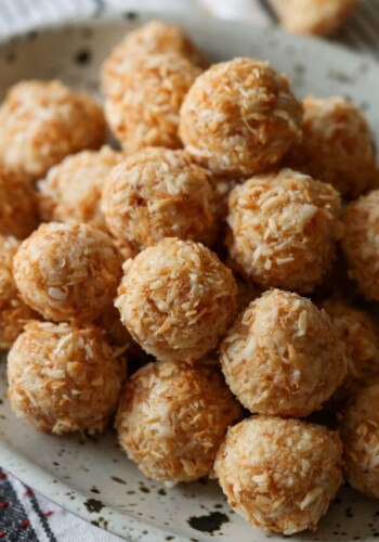 Coconut Balls rolled in toasted coconut on a platter