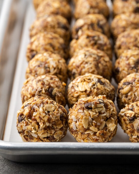 Rows of no-bake chocolate peanut butter energy bites on a baking sheet.