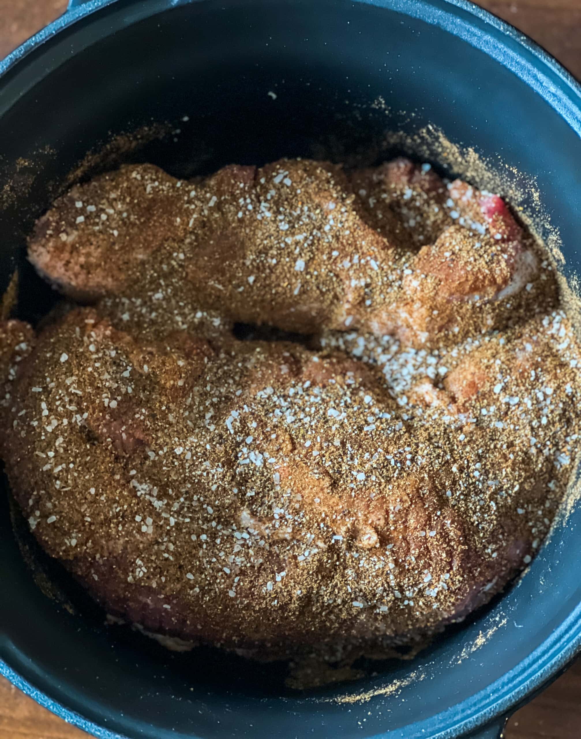 seasoned pork butt in a slow cooker