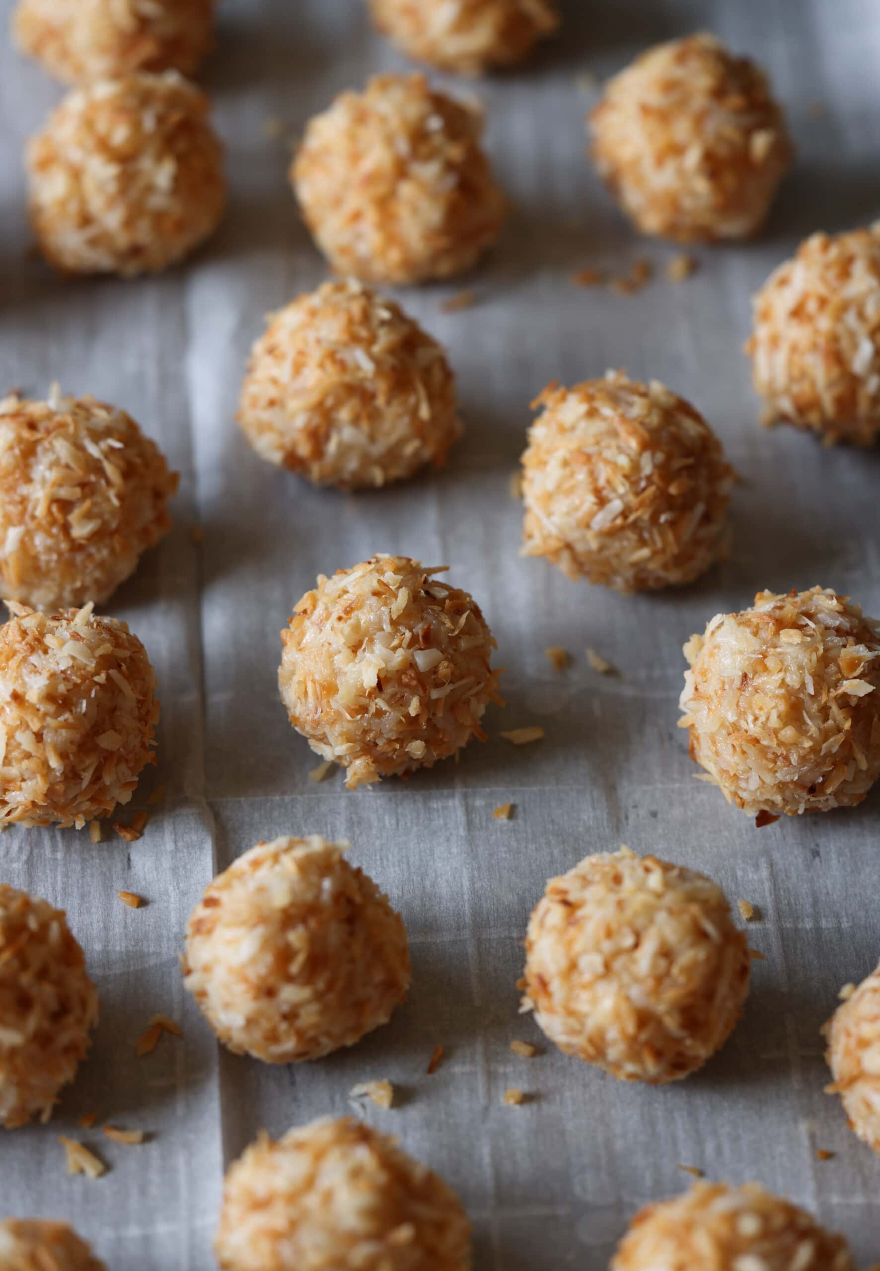 coconut balls on a baking sheet lined with parchment paper