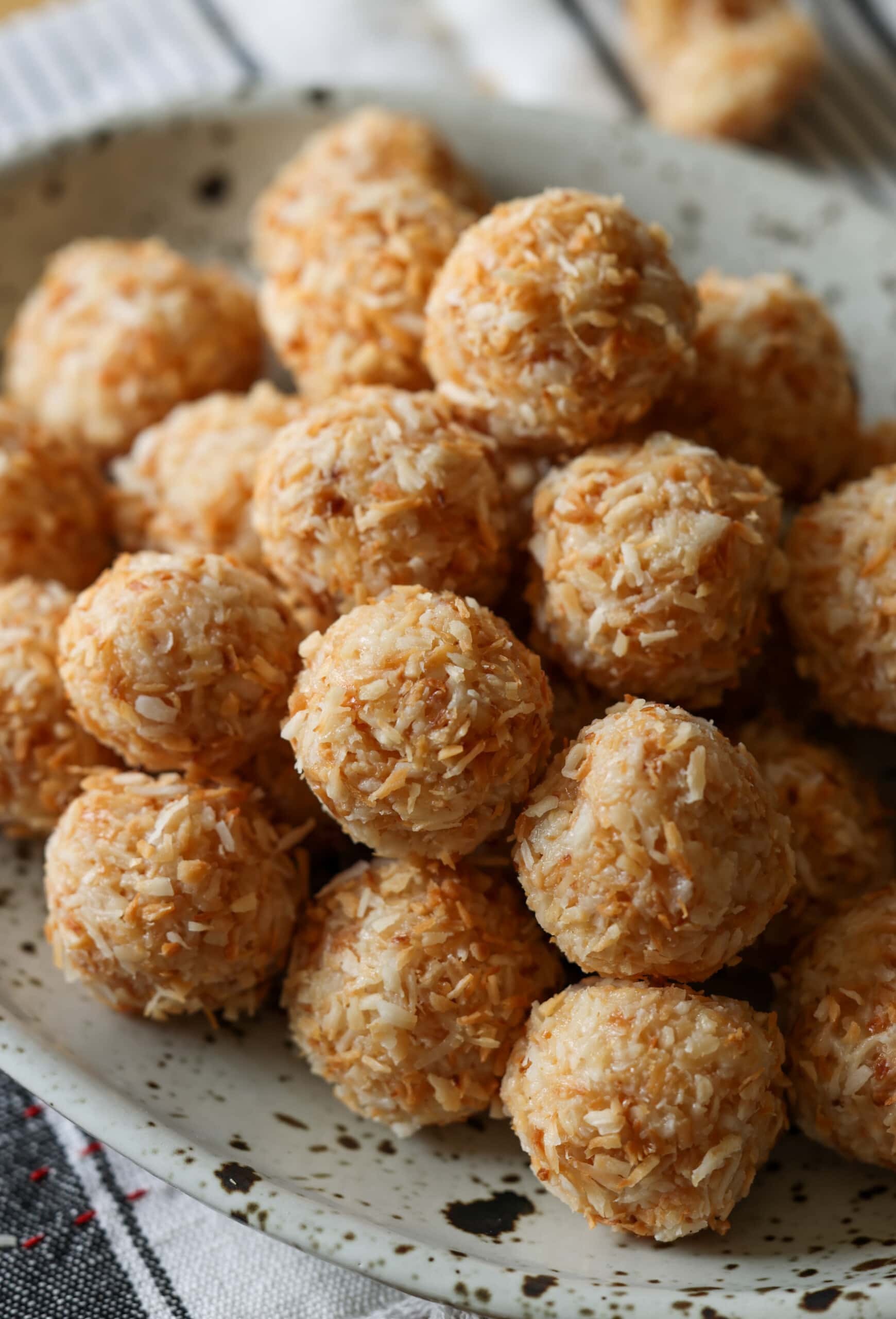 Coconut Balls rolled in toasted coconut on a platter