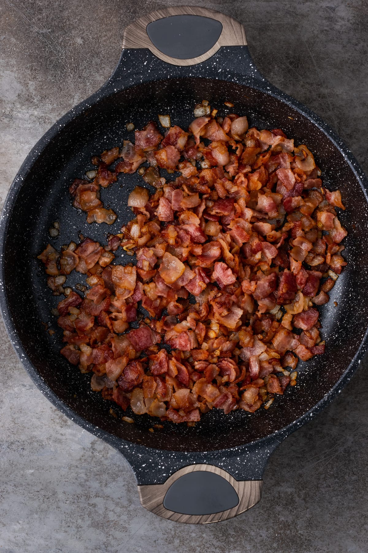 Caramelized onion and bacon in a cast iron skillet.
