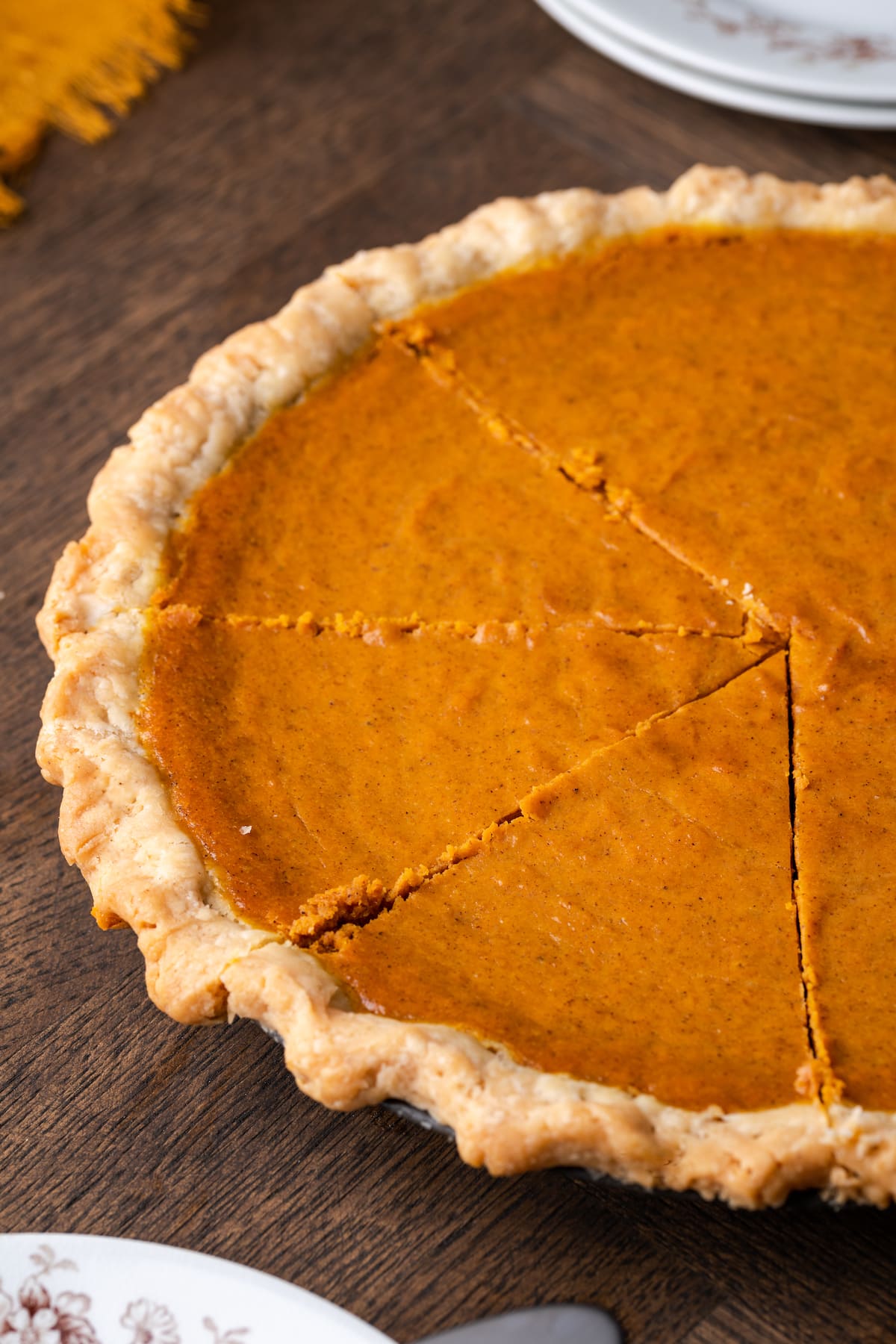 Homemade pumpkin pie cut into slices.