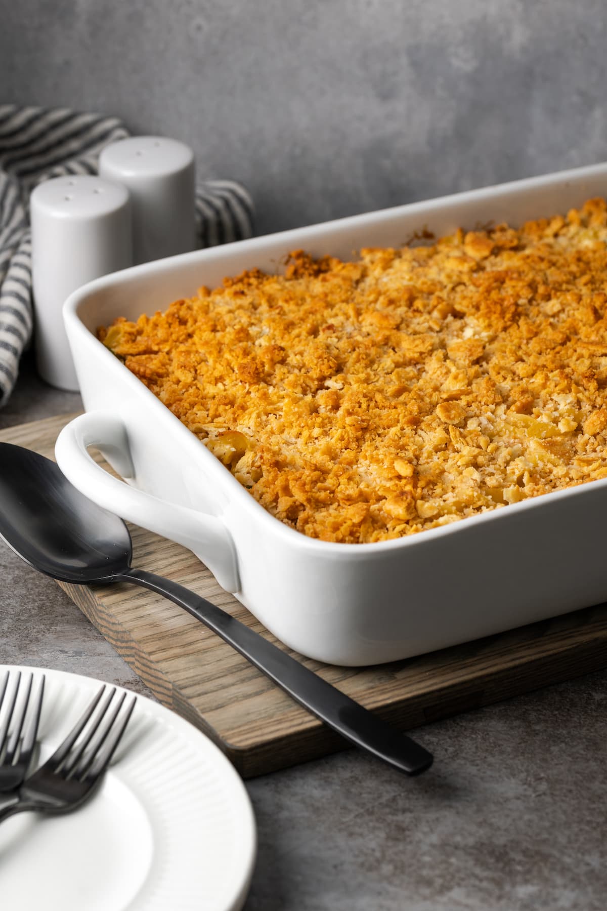 Chicken noodle casserole in a white baking dish topped with crushed Ritz crackers.