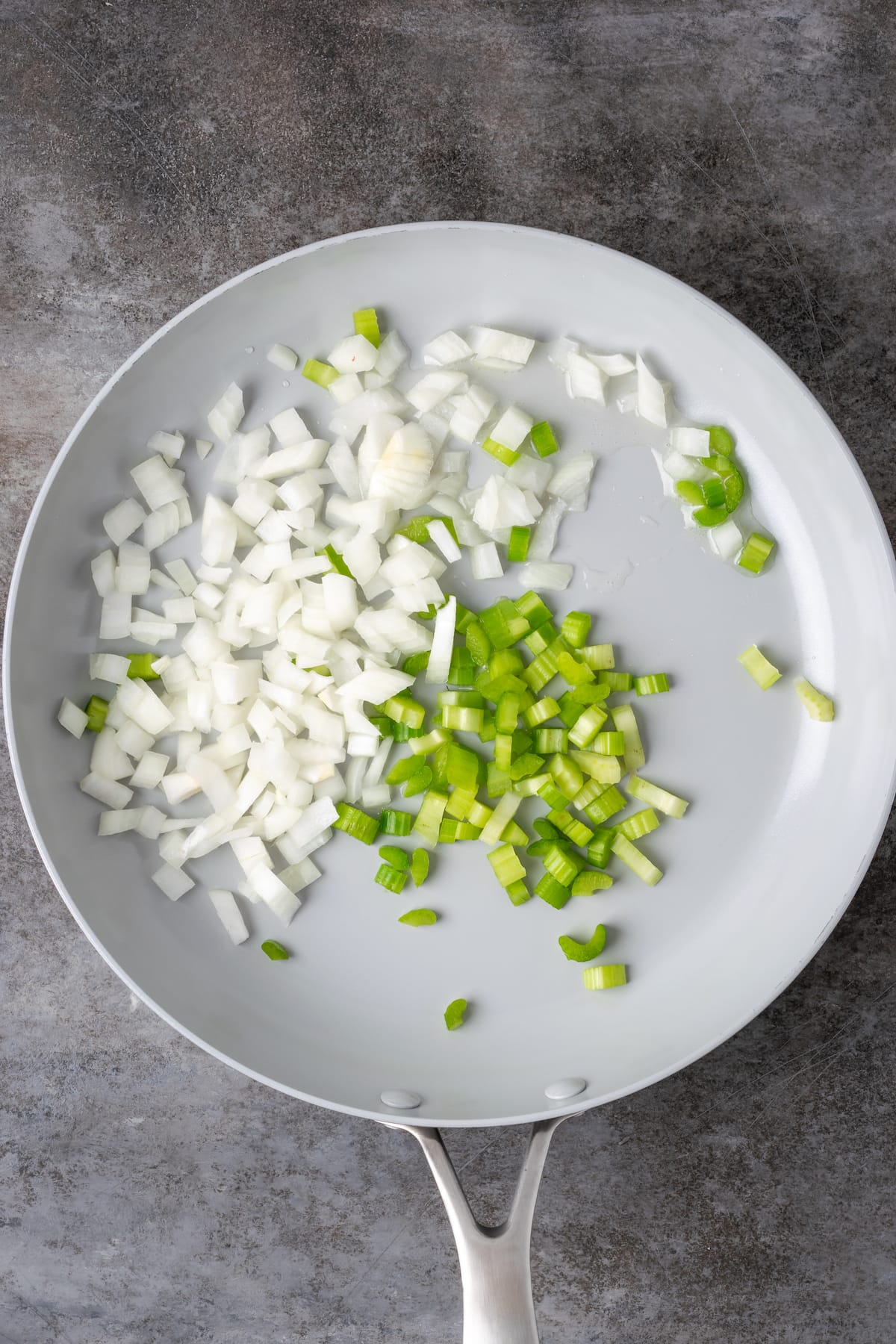Diced celery and onion in a skillet.