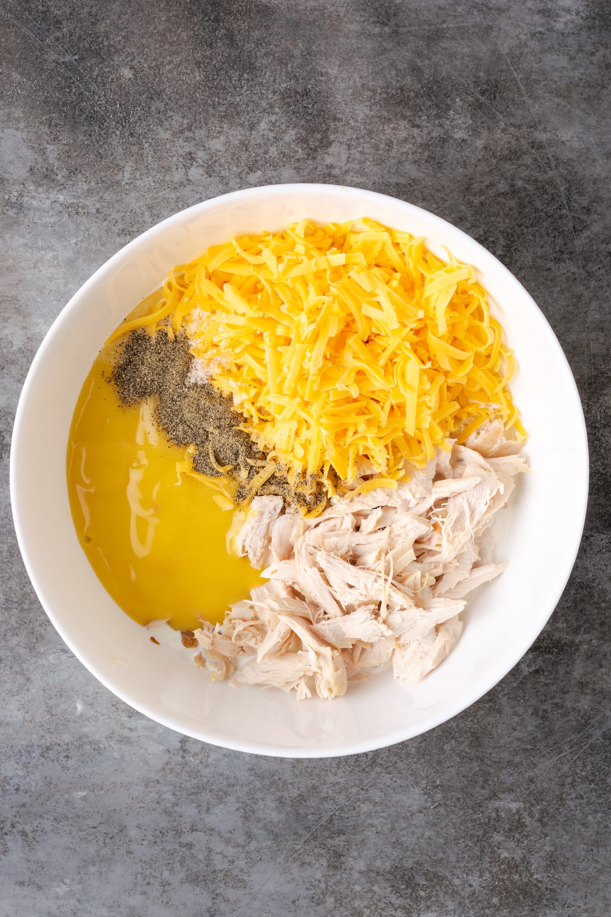 The ingredients for chicken noodle casserole cream sauce combined in a mixing bowl.