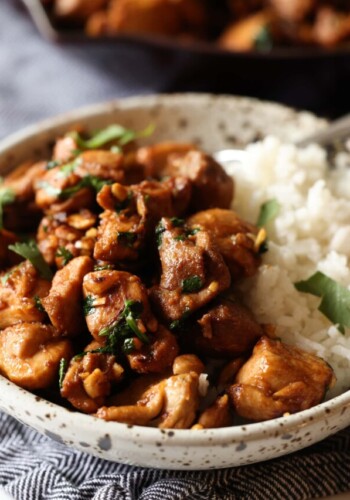 Ginger chicken served in a bowl over rice, garnished with fresh chopped coriander.