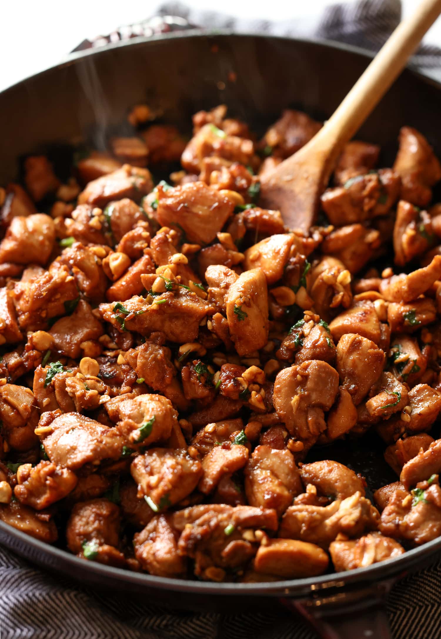 Cook the ginger chicken in a cast iron skillet, stirring with a wooden spoon.