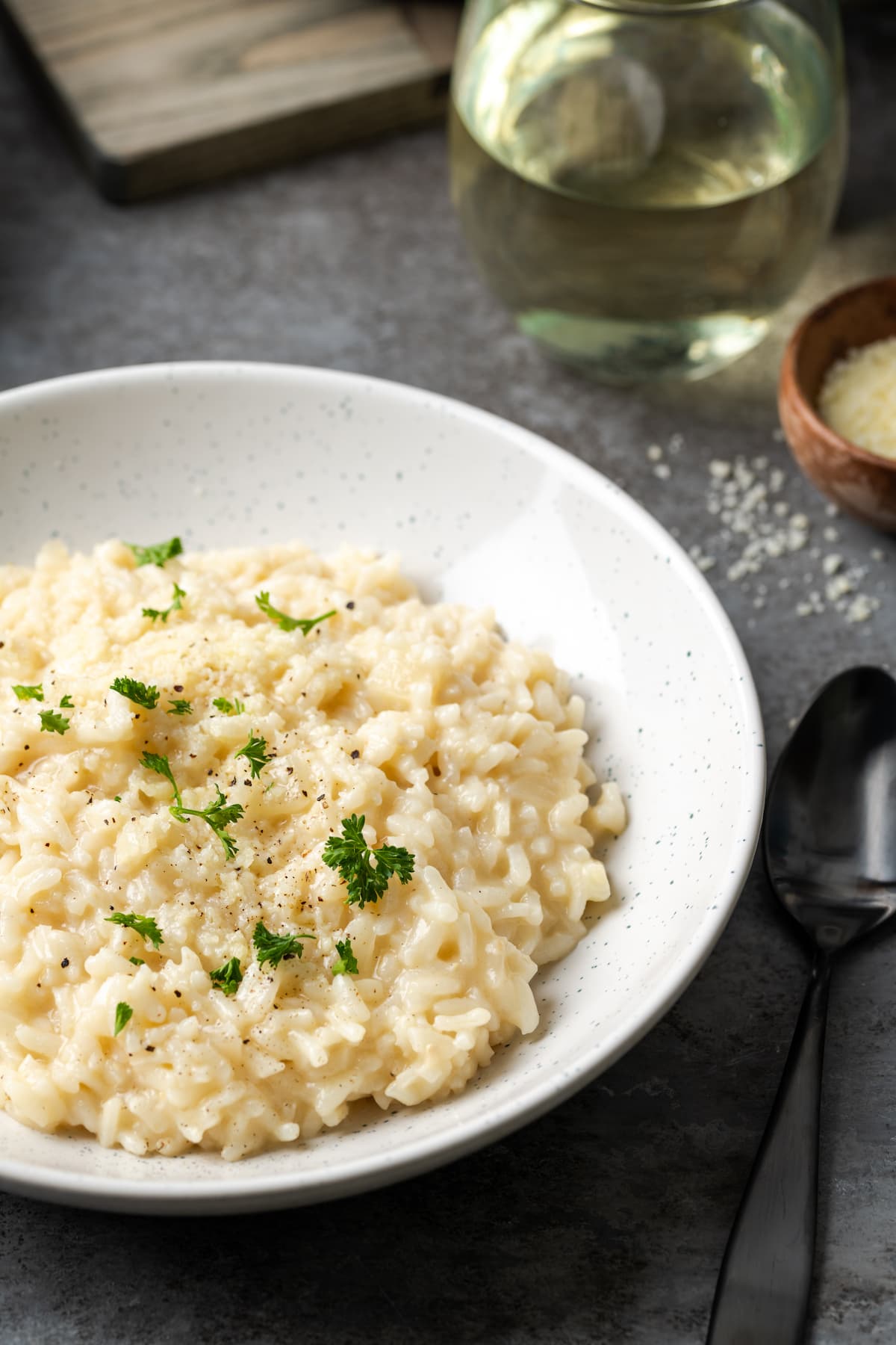 A bowl of creamy Instant Pot risotto garnished with fresh parsley.