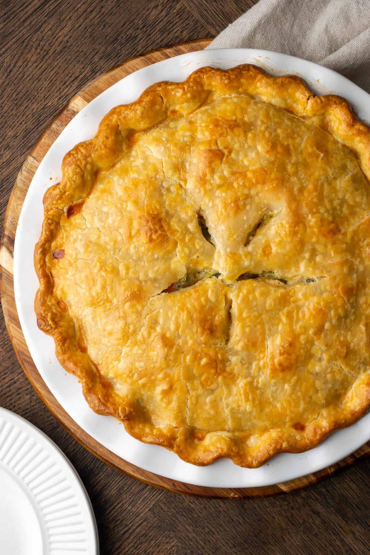 Overhead view of baked chicken pot pie in a pie plate.