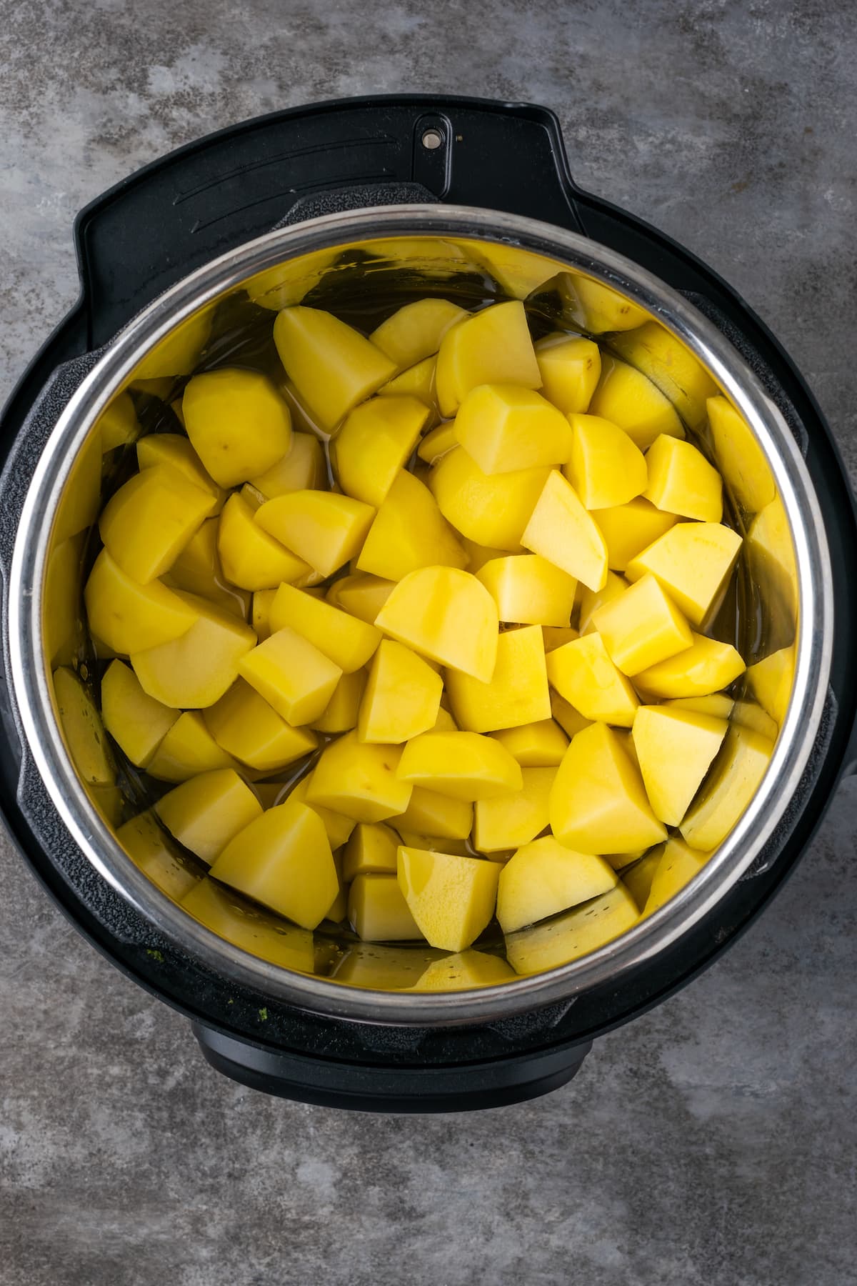 Chopped cooked potatoes inside an Instant Pot.