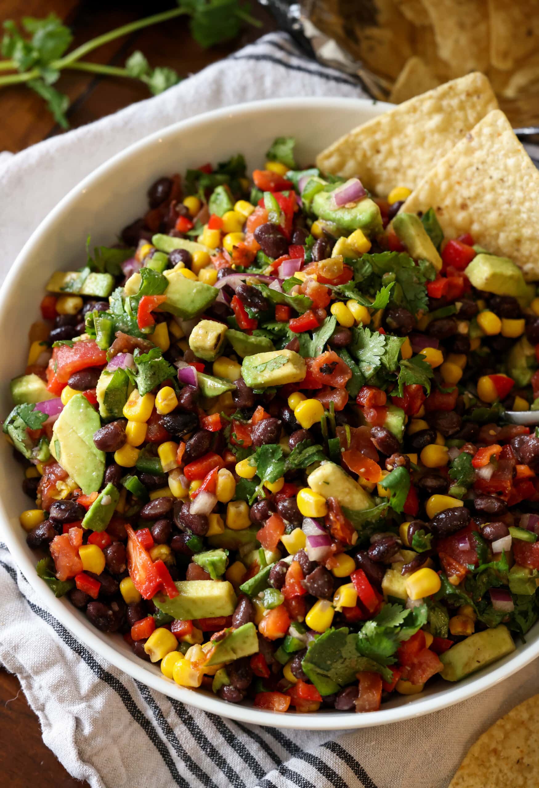 A bowl of Texas caviar with a chip in it