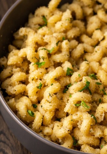 Close up of garlic bread pasta in a pot.