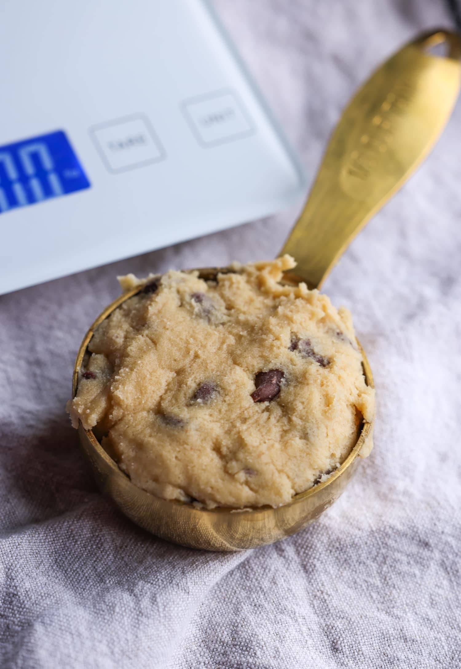 1/3 cup of cookie dough in a measuring cup