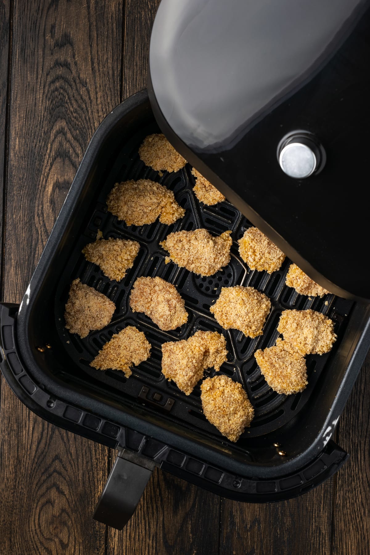 Overhead view of popcorn chicken cooking inside the air fryer.