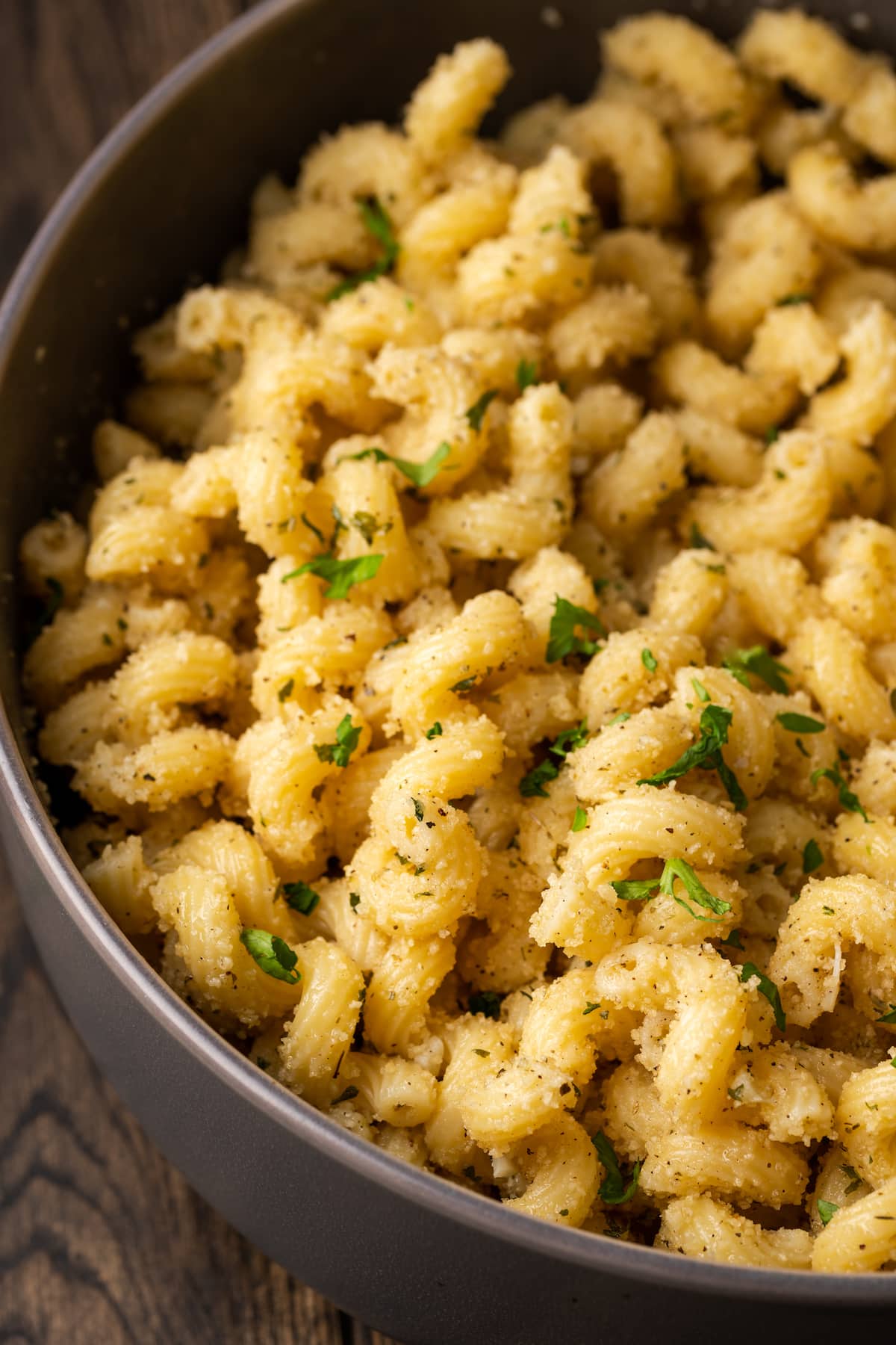 Close up of garlic bread pasta in a pot.