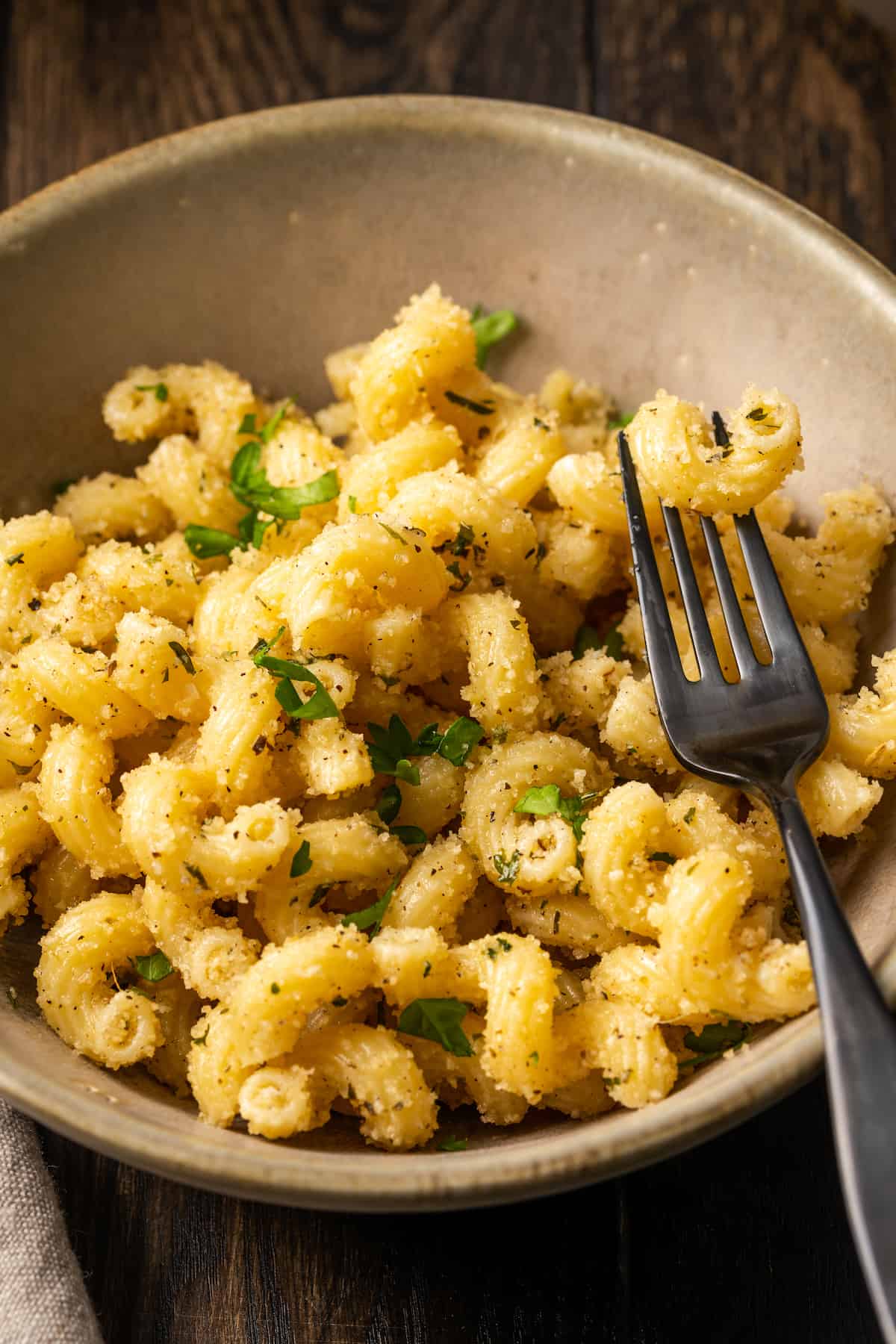 Garlic bread pasta in a bowl with a fork.