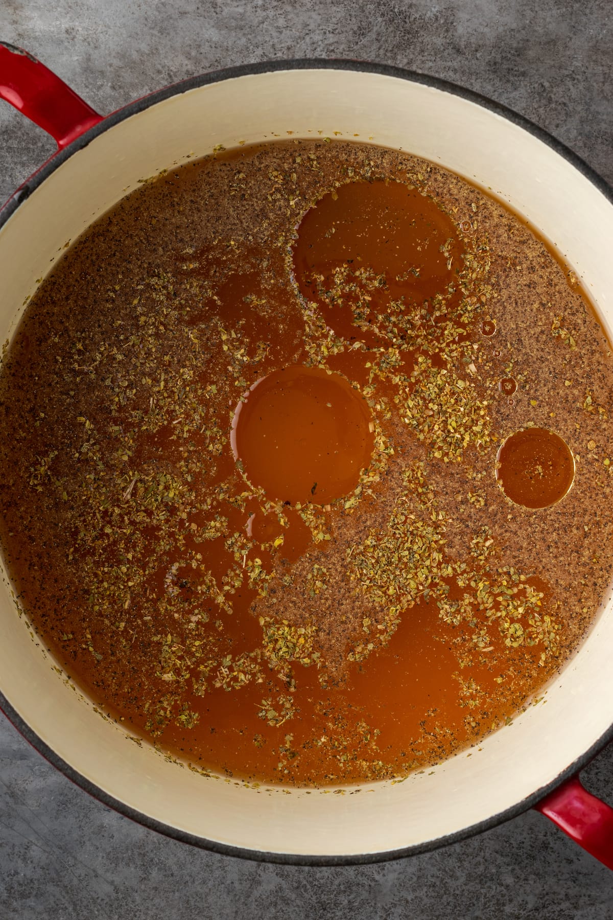 Tomatoes and broth simmering in a large pot.