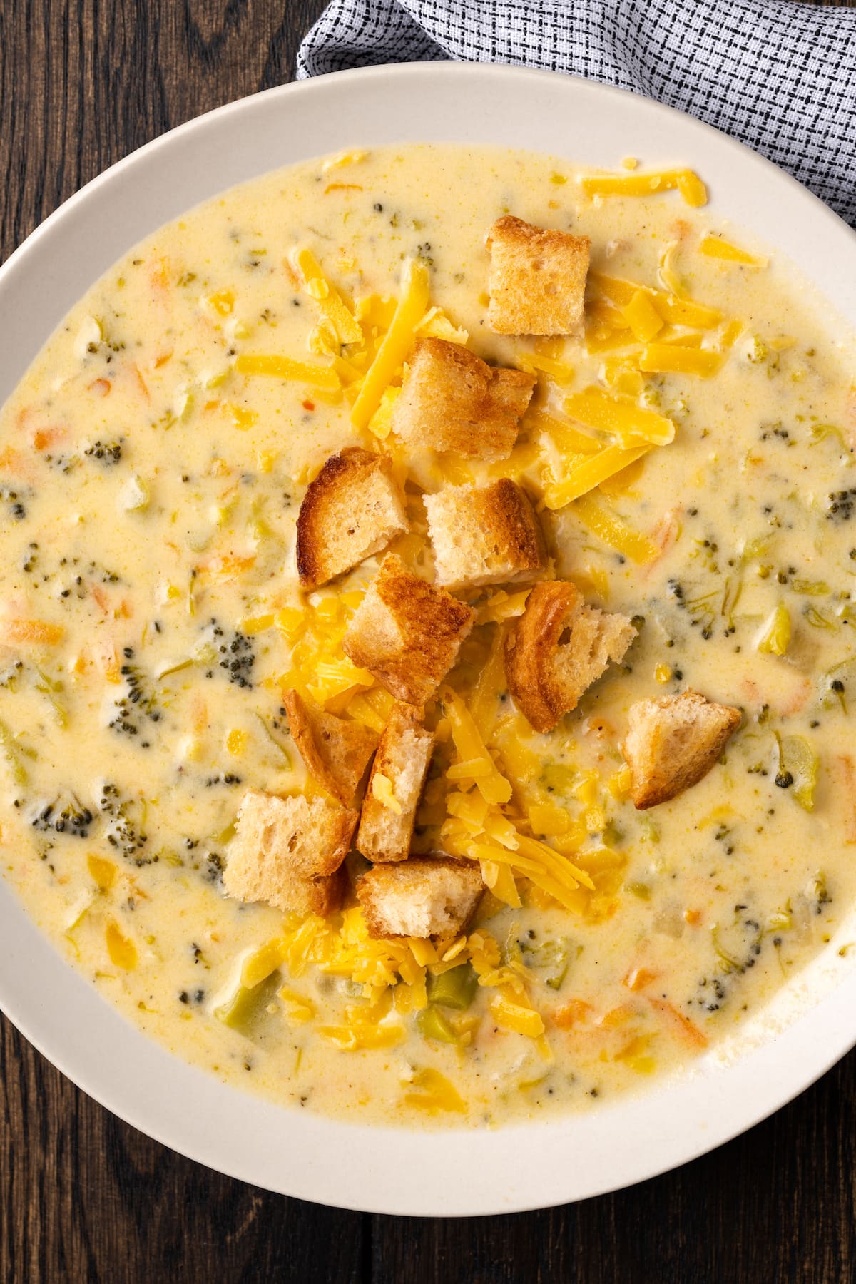 Overhead view of a bowl of instant pot broccoli cheddar soup topped with croutons.
