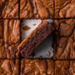 Overhead view of Nutella brownies cut into squares, with one brownie turned on its side.