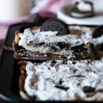 serving Oreo Slab Cheesecake with a spatula