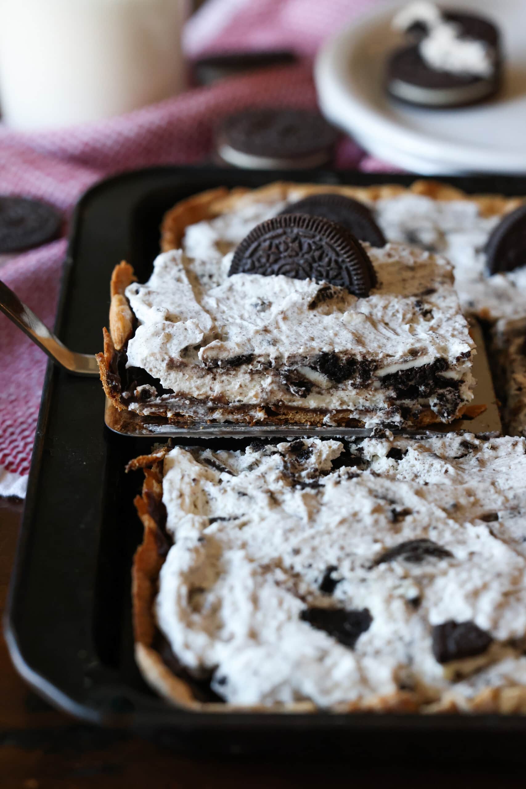 Oreo slab pie is sliced ​​and served
