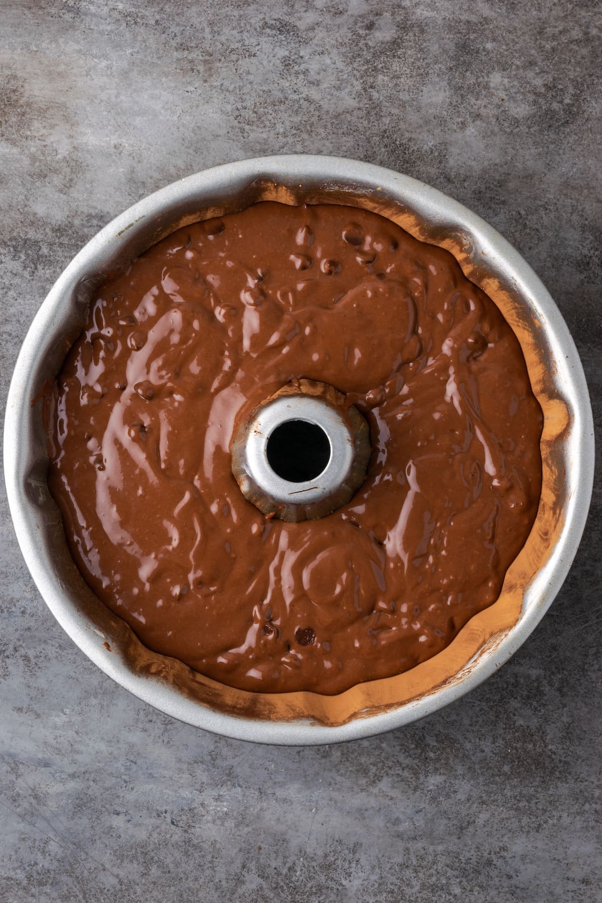 Chocolate cake batter in a 10-inch bundt pan.