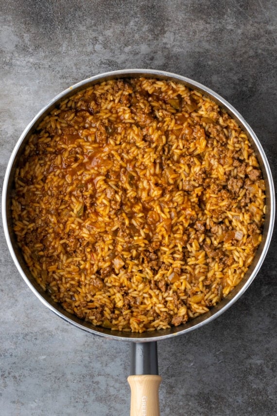 Cooked taco rice in a skillet.