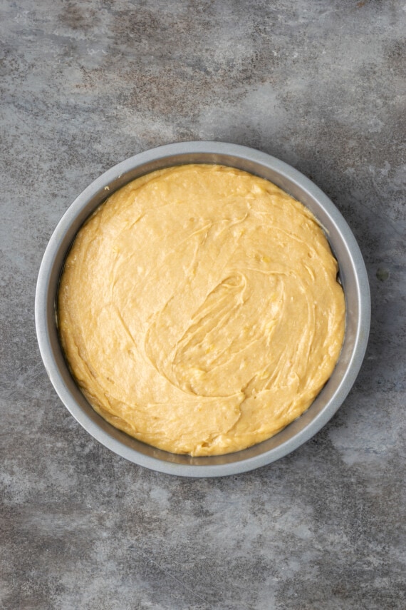 Banana blondie batter spread into a round baking pan.