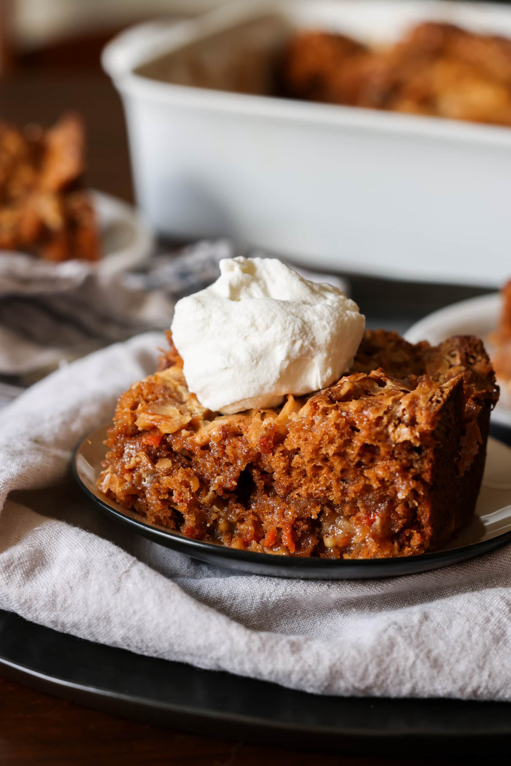 Earthquake cake with whipped cream on a carrot cake plate