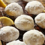 Lemon Cooler Cookies on a wire cooking rack coated in powdered sugar