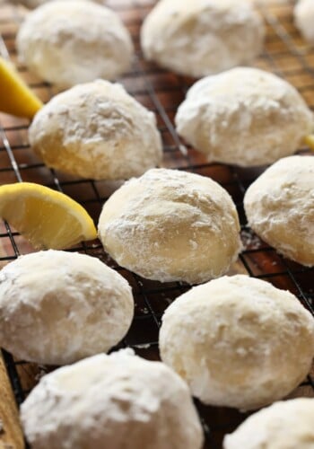 Lemon Cooler Cookies on a wire cooking rack coated in powdered sugar