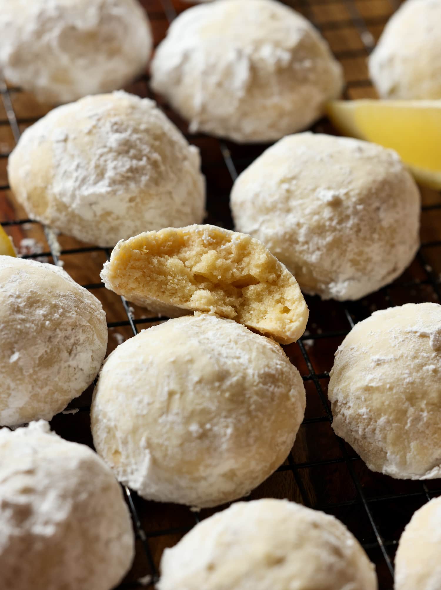 Lemon biscuit covered with halved powdered sugar on a cooling rack