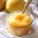 Lemon Curd in a glass jar with a spoon