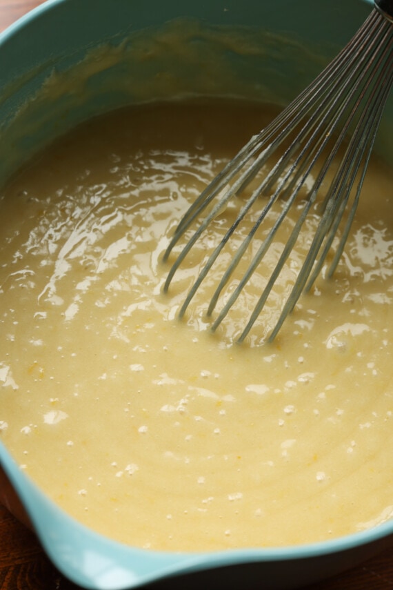 lemon cake batter in a bowl with a whisk