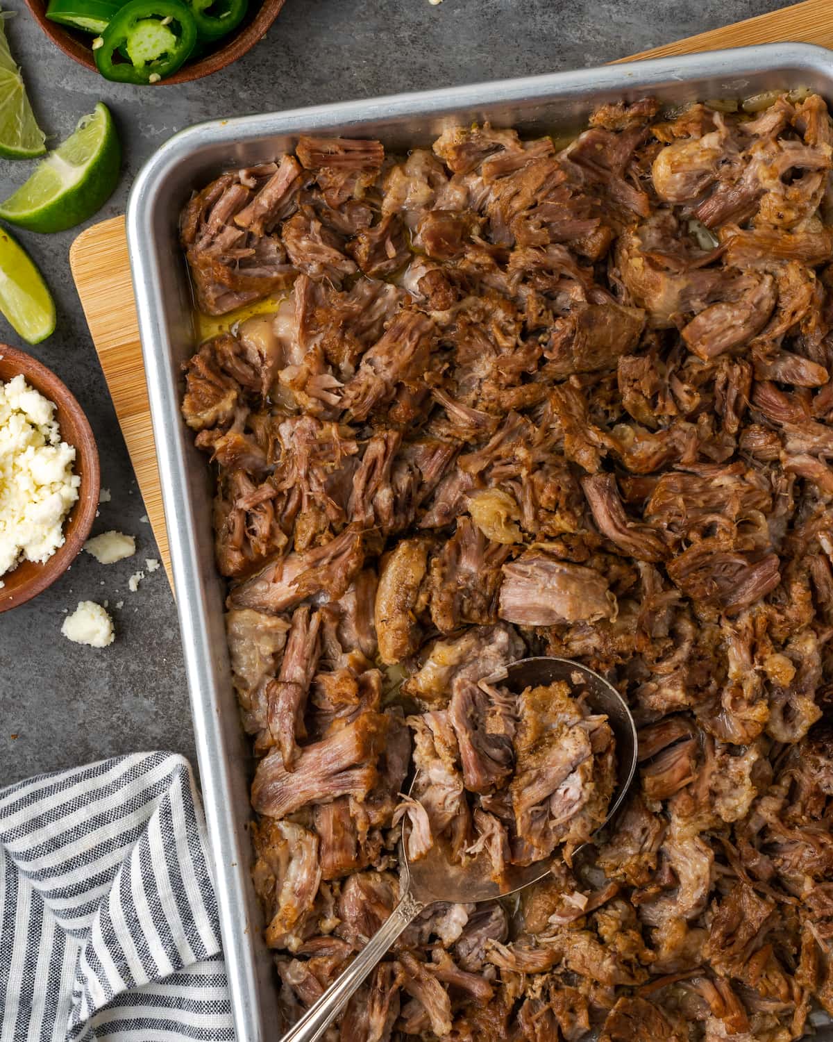 Overhead view of instant pot carnitas on a metal baking sheet.