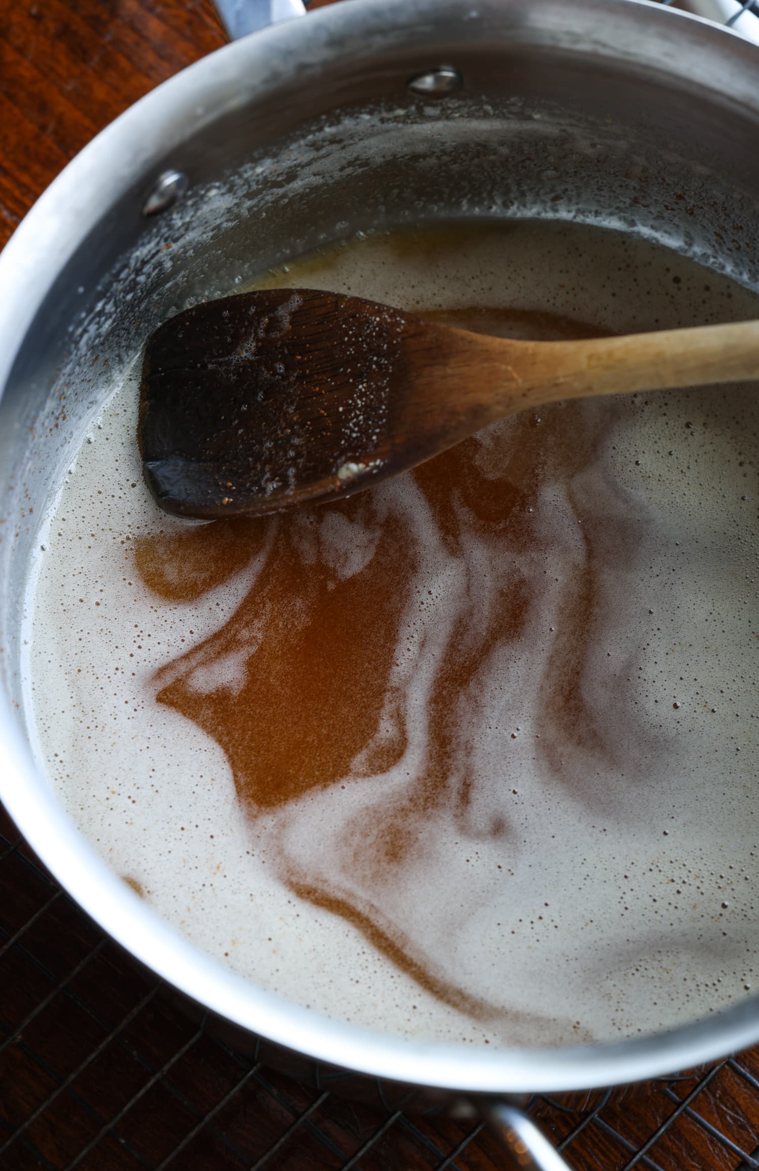 browned butter in a saucepan with a wooden spoon