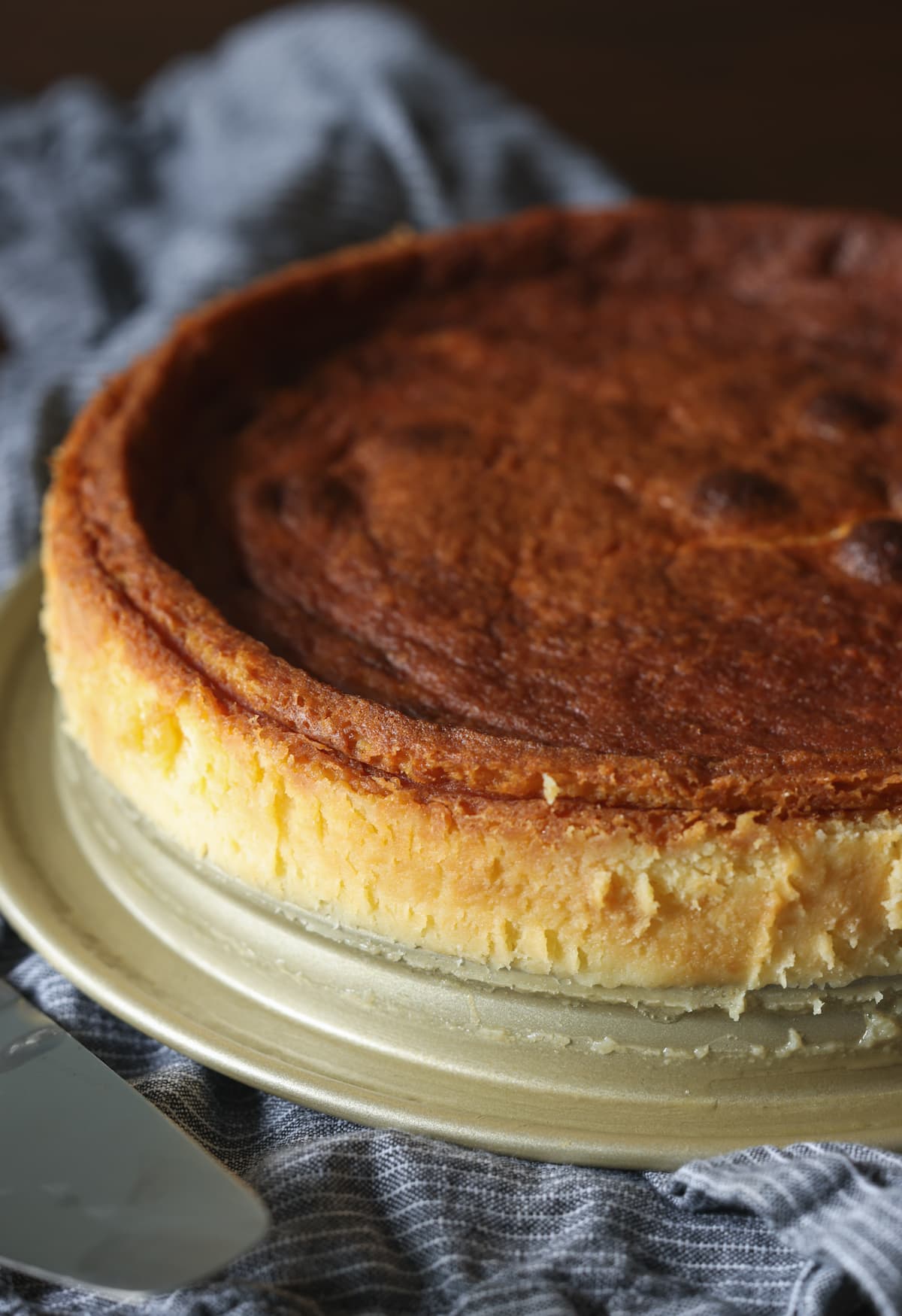 Baked flourless white chocolate cake on a plate.