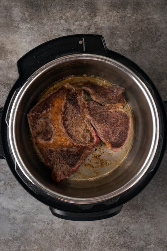 Browned chuck roast inside the instant pot.