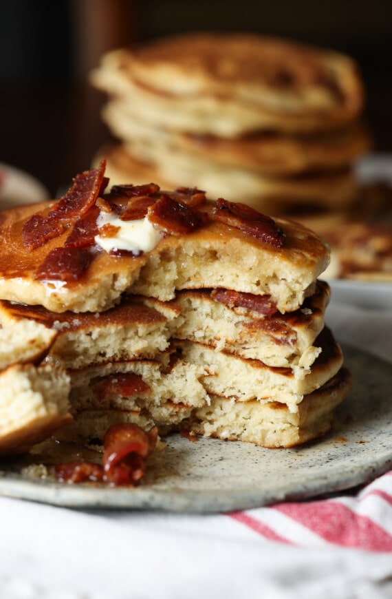Maple bacon pancakes served on a plate cut so that the inside is visible