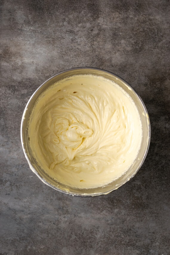 Flourless white chocolate cake batter in a metal mixing bowl.